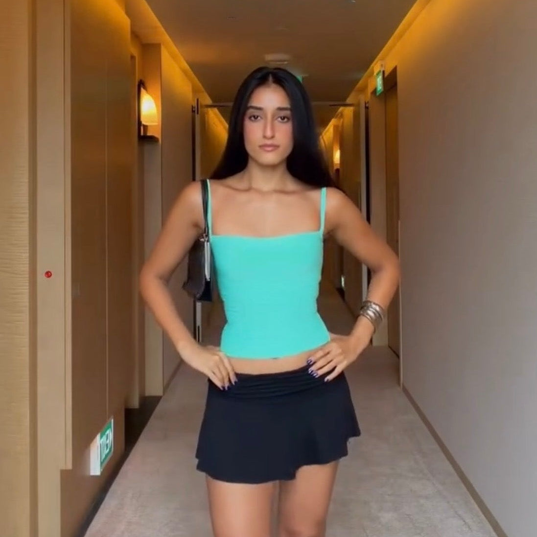 Influencer Mannat Sandhu in the Tiffany teal square neck bandage top by Casual Threat with a black mini skirt