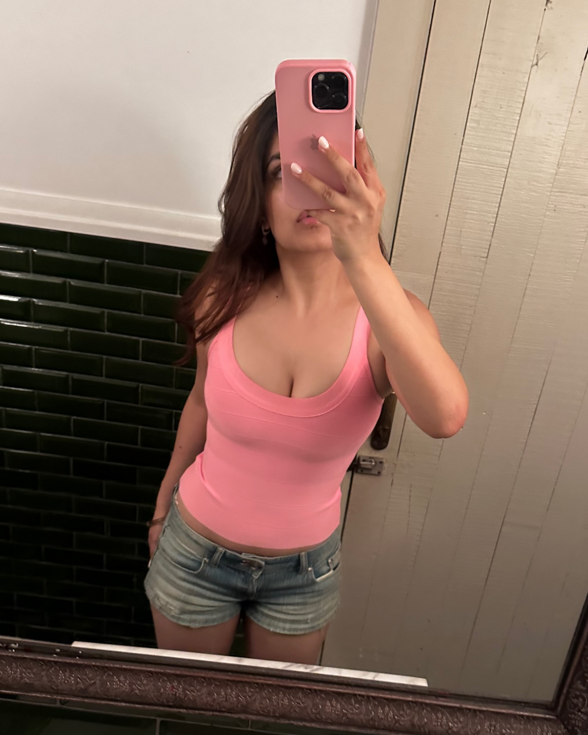 Nandini Sharma wearing the Casual Threat Regina blush pink bandage top in a mirror selfie